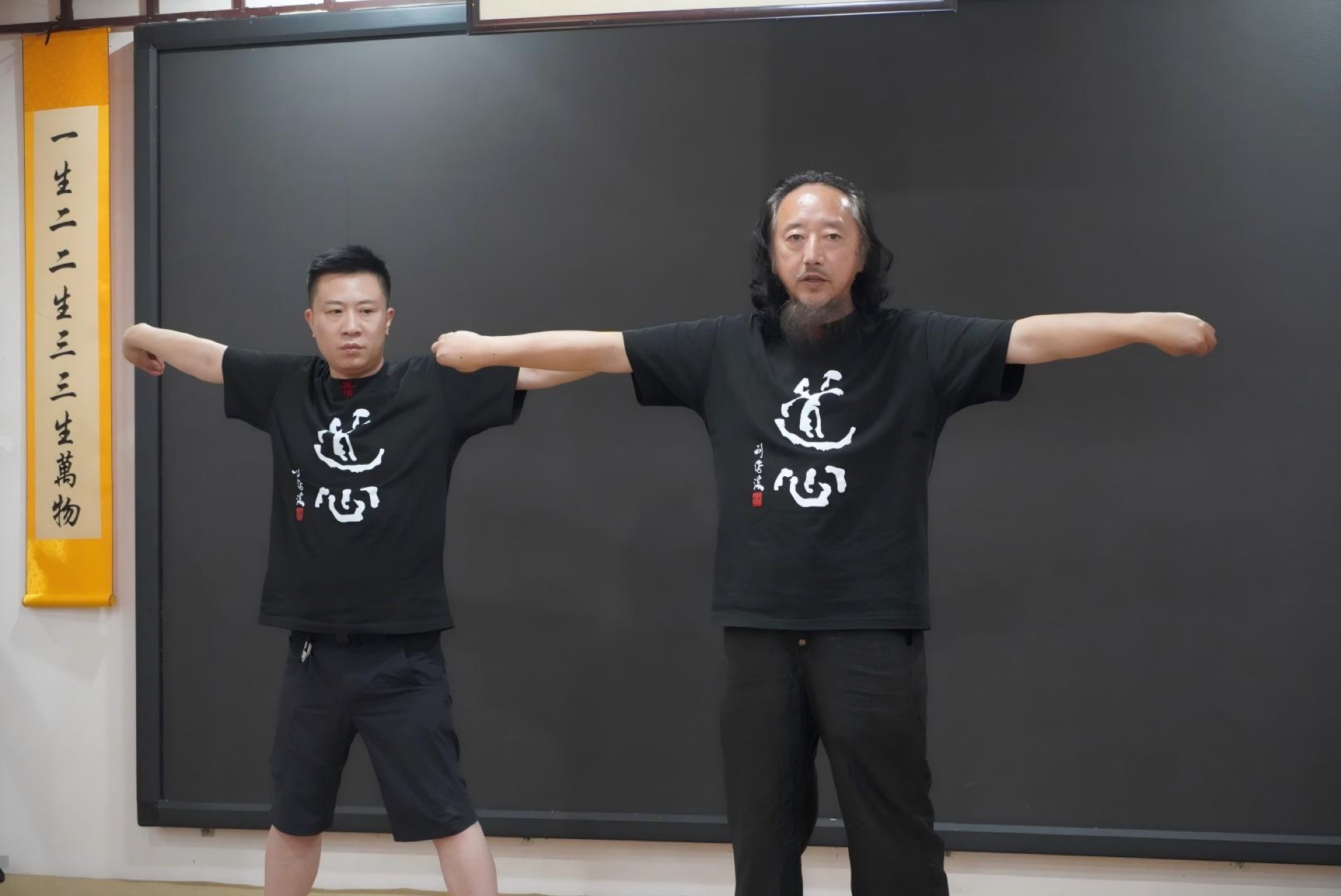 Qingcheng instructors demonstrating a standing form